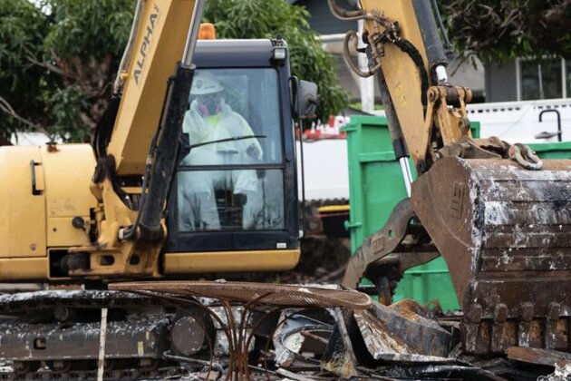 Photo: Excavators work to clear toxic debris