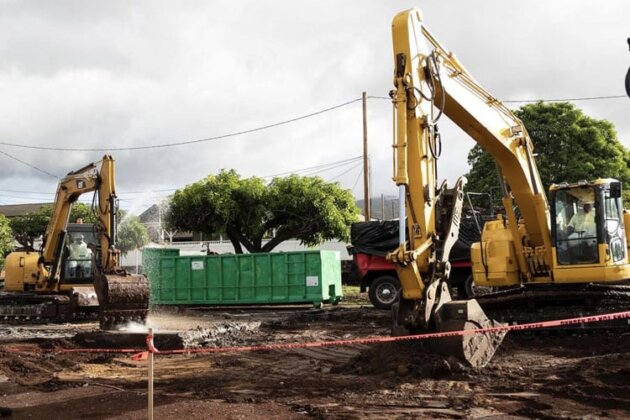 Photo: Excavators work to clear toxic debris