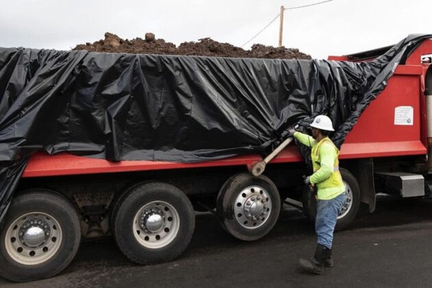 Photo: Crews load trucks bound for hazardous landfills