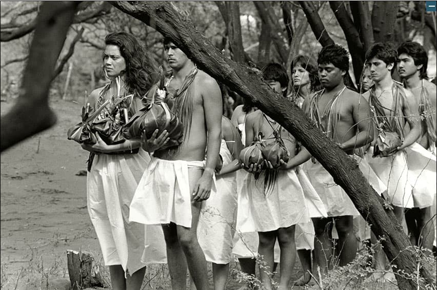 Photo: Craig and Luana Neff stand at the front of a procession waiting to offer hoʻokupu at a Makahiki ceremony at Hakioawa, Kaho’olawe
