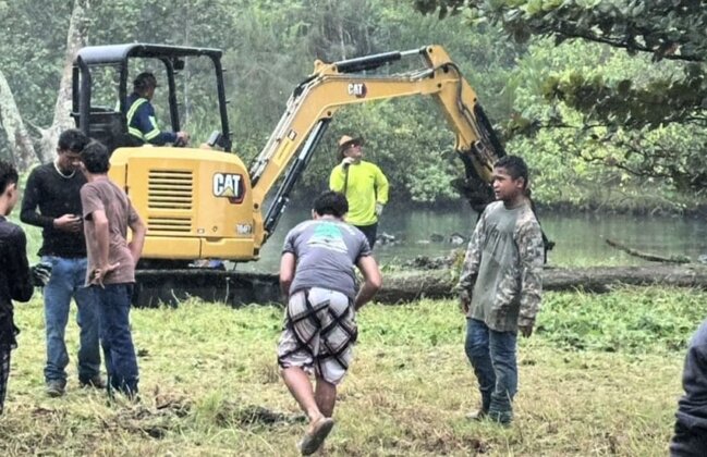 Photo: Excavator working to clear debris at Puhi Bay
