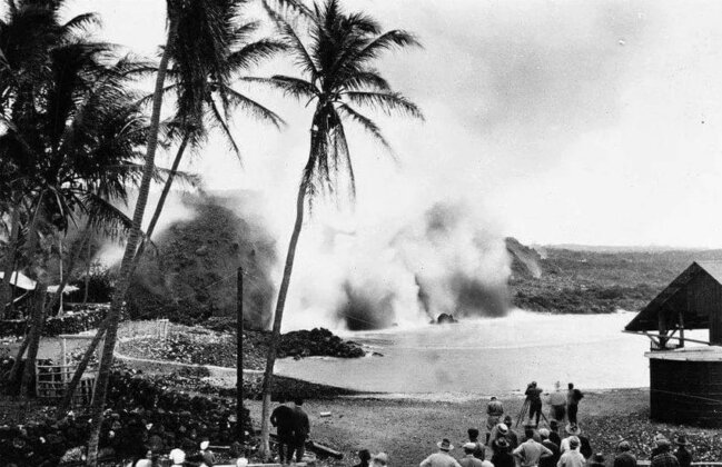 Photo: Residents of Hoʻōpūloa and onlookers watch as the lava meets the sea